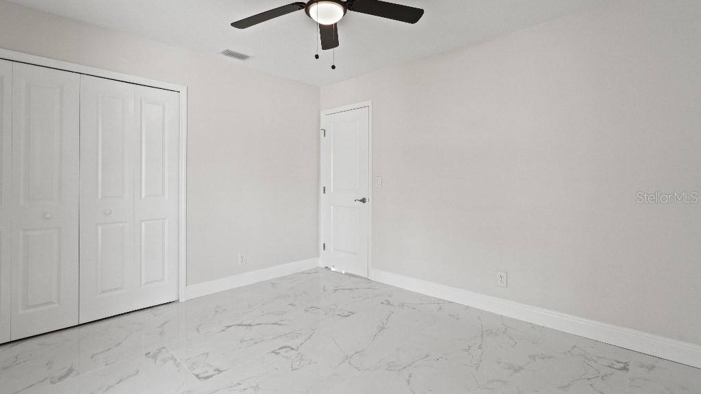1024 Spindle Palm Way Apollo Beach, FL 33572 - Photo 32 of 50 an empty room with a ceiling fan