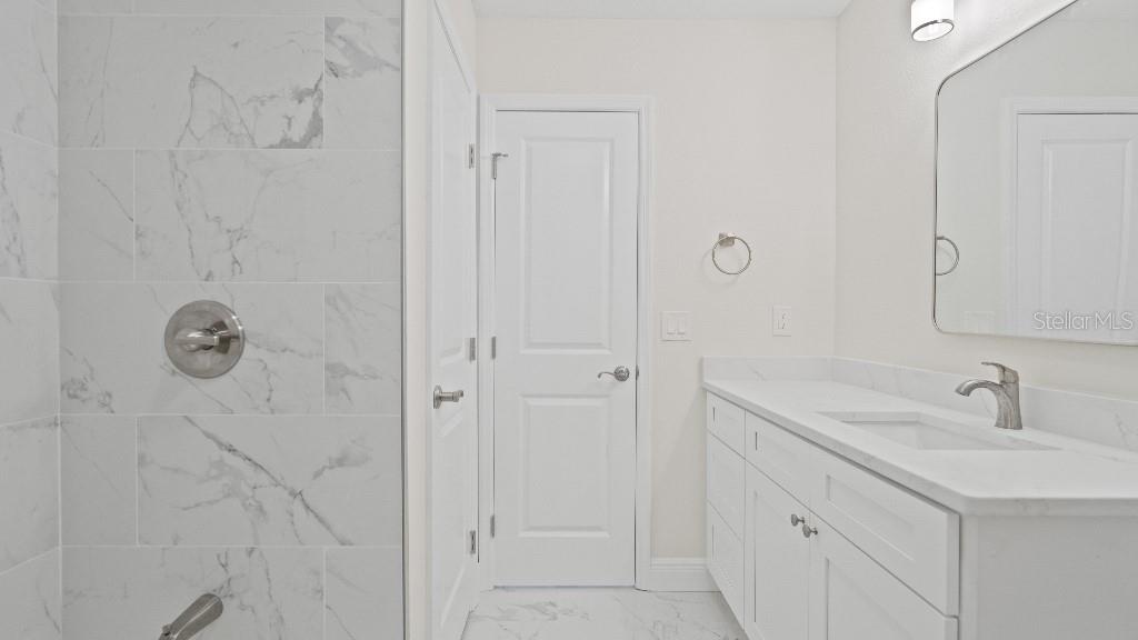 1024 Spindle Palm Way Apollo Beach, FL 33572 - Photo 4 of 50 a bathroom with a sink and mirror