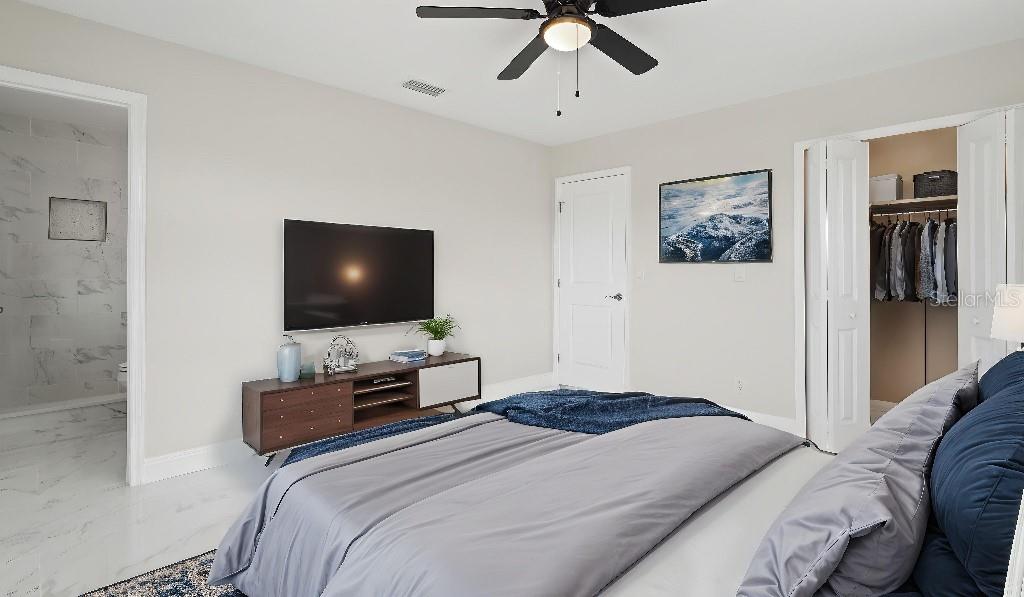 1024 Spindle Palm Way Apollo Beach, FL 33572 - Photo 49 of 50 a bedroom with a bed and a flat screen tv