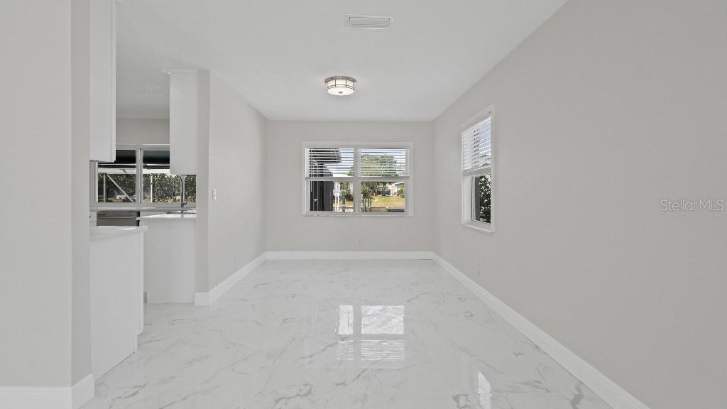 1024 Spindle Palm Way Apollo Beach, FL 33572 - Photo 9 of 50 an empty room with windows