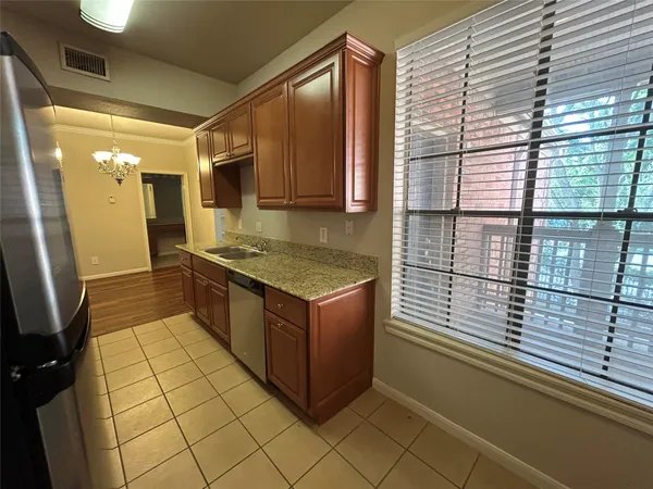 a kitchen with stainless steel appliances granite countertop a sink and a stove