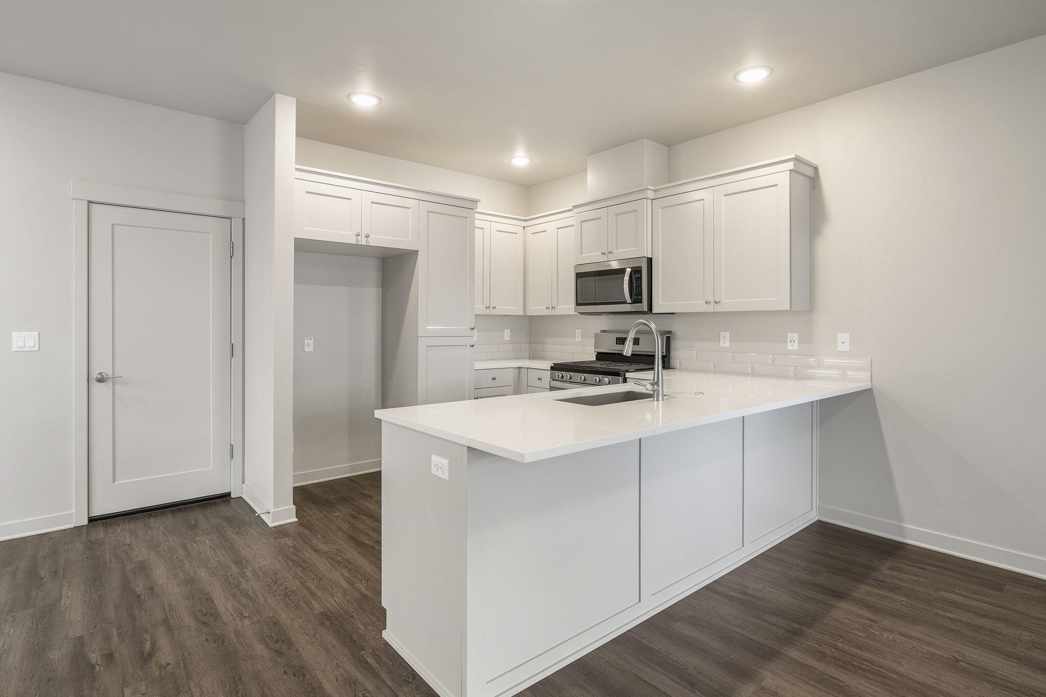 2366 Northeast Victor Place Bend, OR 97701 - Photo 8 of 31 a kitchen with kitchen island a sink stainless steel appliances and cabinets