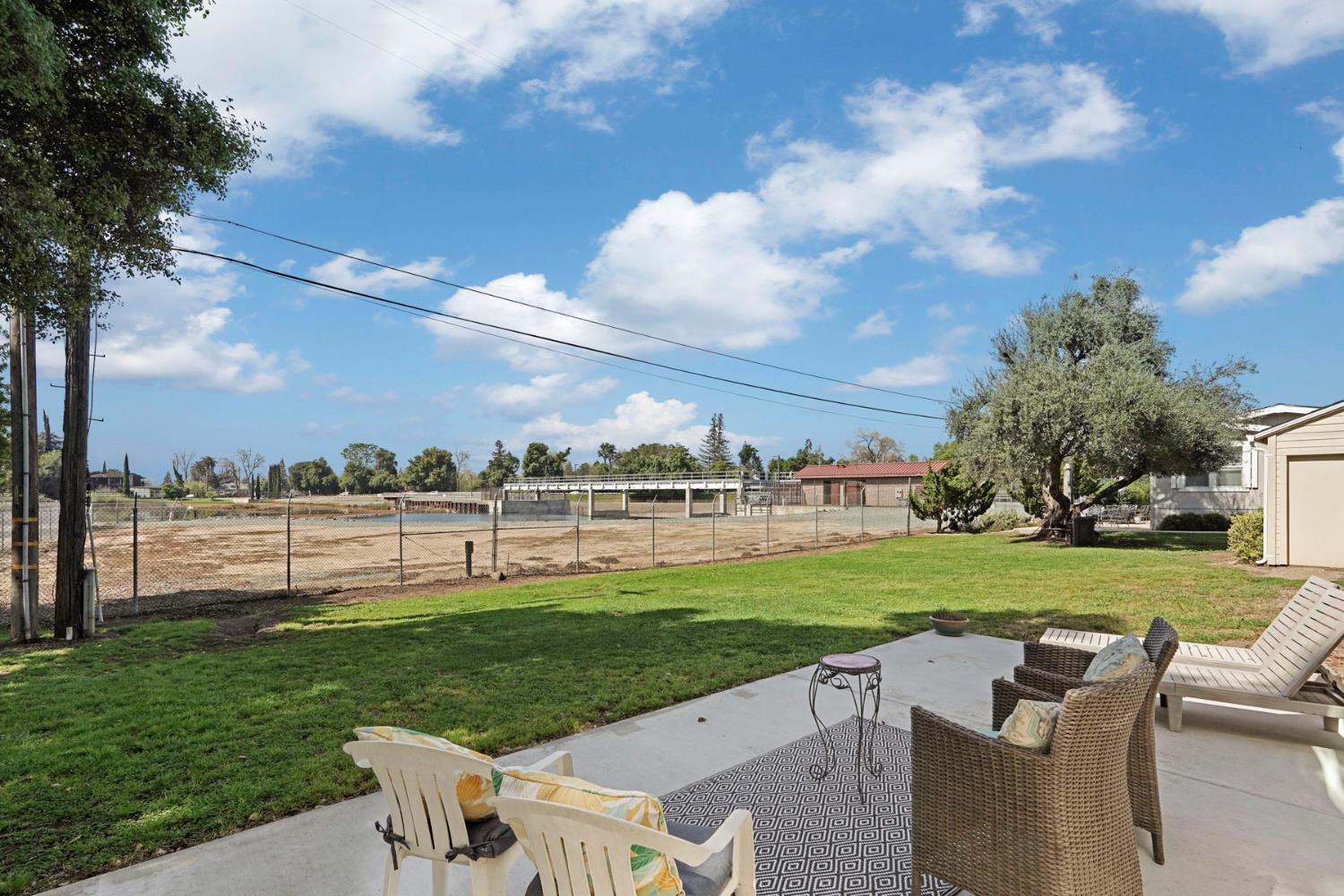19250 North Lower Sacramento Road, Unit 22 Woodbridge, CA 95258 - Photo 22 of 30 a view of a wooden deck and a big yard