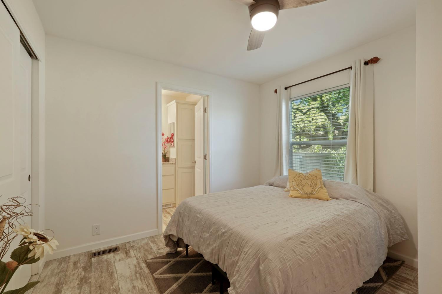 19250 North Lower Sacramento Road, Unit 22 Woodbridge, CA 95258 - Photo 10 of 30 a bedroom with a bed and a window