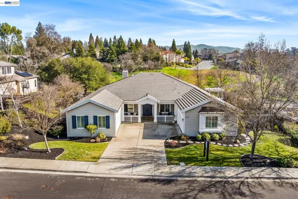 a front view of house with yard and green space