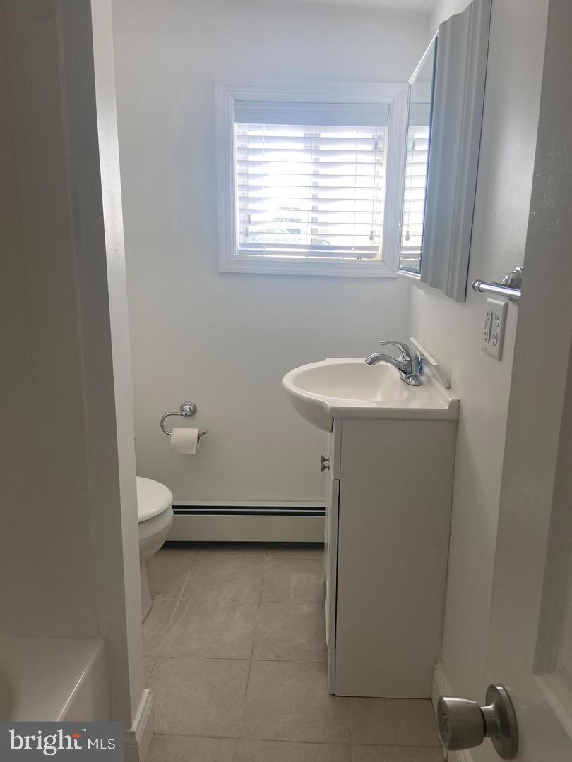 163 Klockner Road Trenton, NJ 08619 - Photo 11 of 22 a bathroom with a sink toilet and window