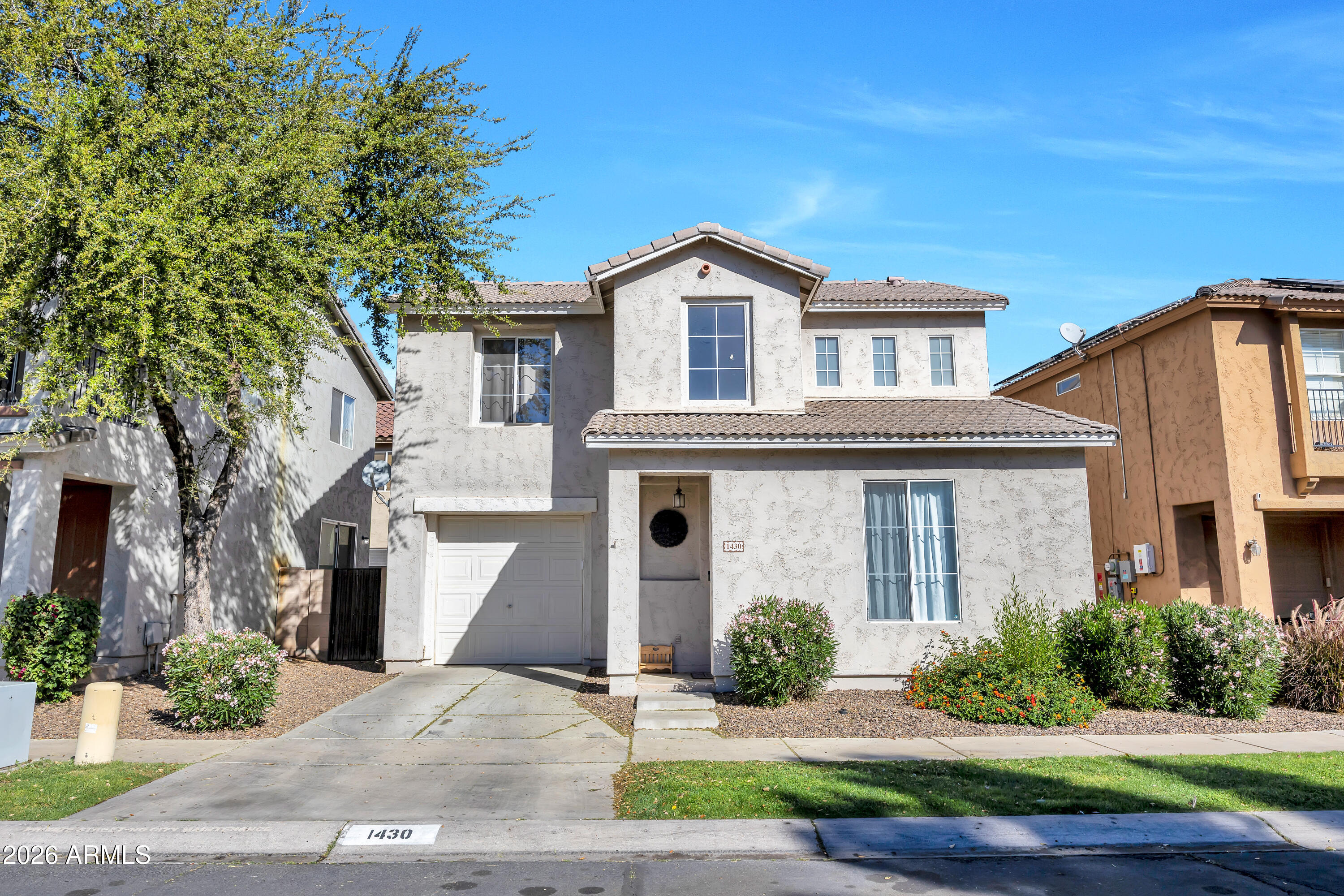 1430 East Romley Road Phoenix, AZ 85040 - Photo 1 of 24 a front view of a house with a yard and garage