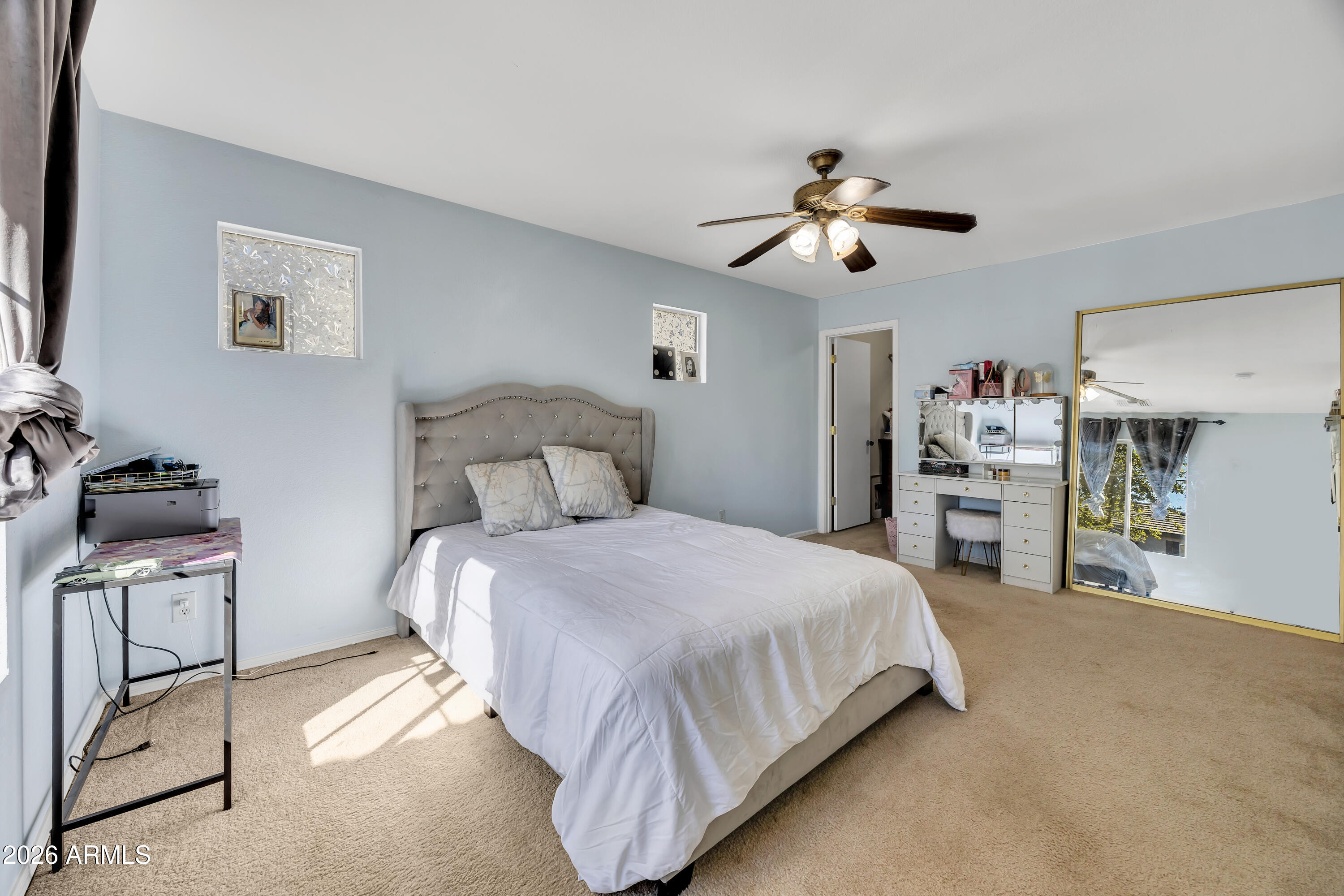 1430 East Romley Road Phoenix, AZ 85040 - Photo 17 of 24 a bedroom with a bed and a chandelier