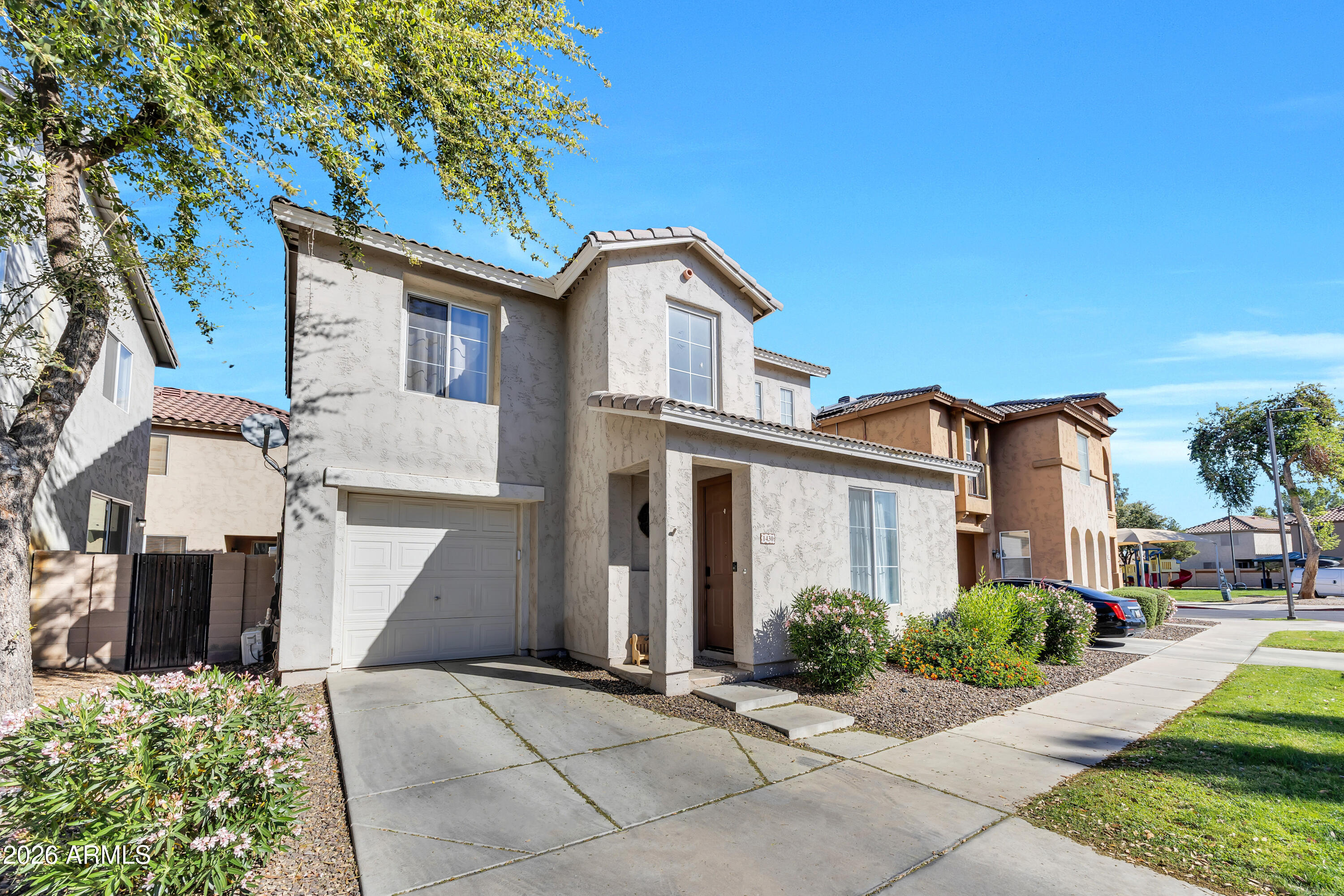 1430 East Romley Road Phoenix, AZ 85040 - Photo 2 of 24 a front view of a house with a yard