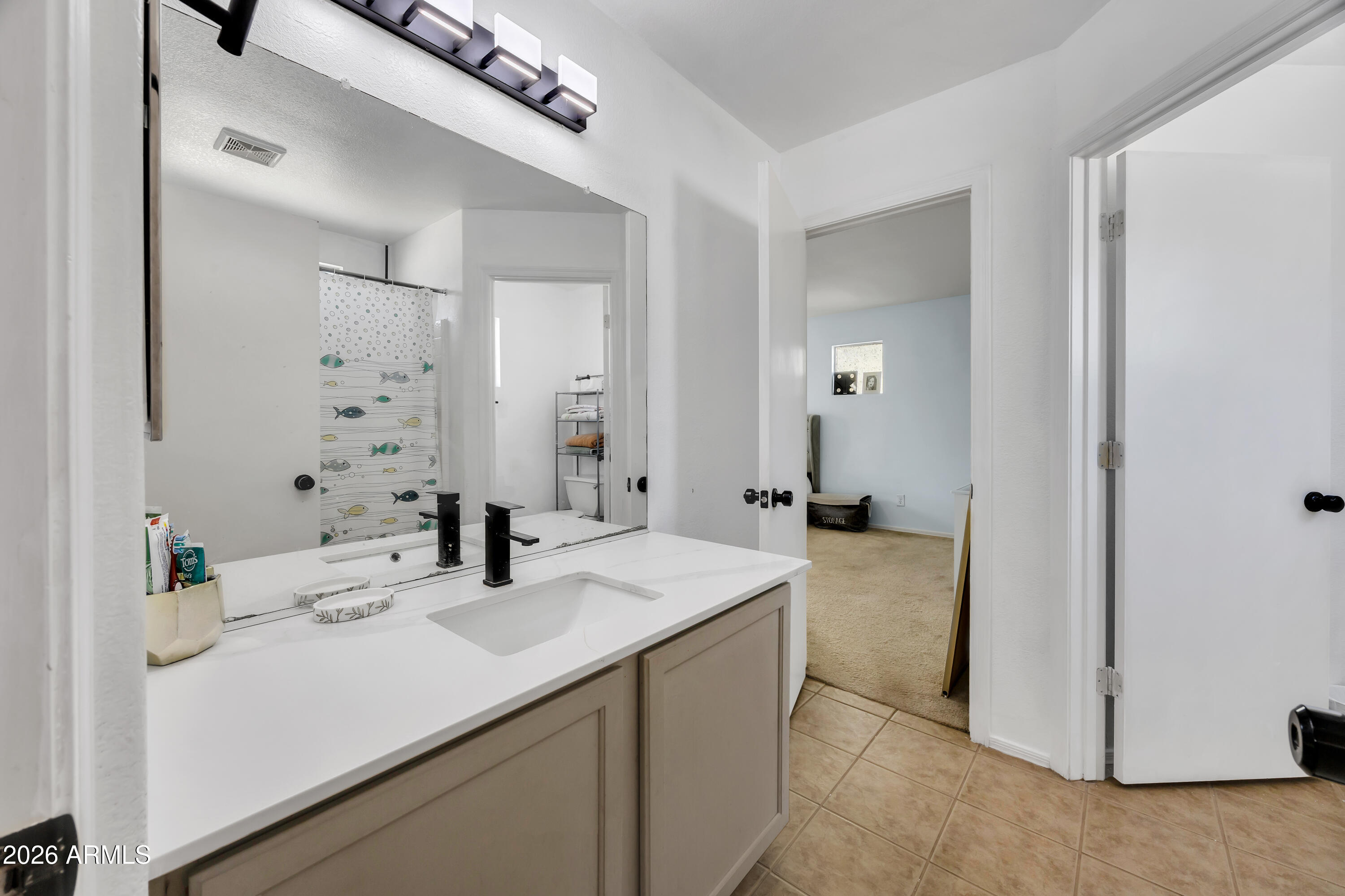 1430 East Romley Road Phoenix, AZ 85040 - Photo 21 of 24 a bathroom with a sink and a mirror