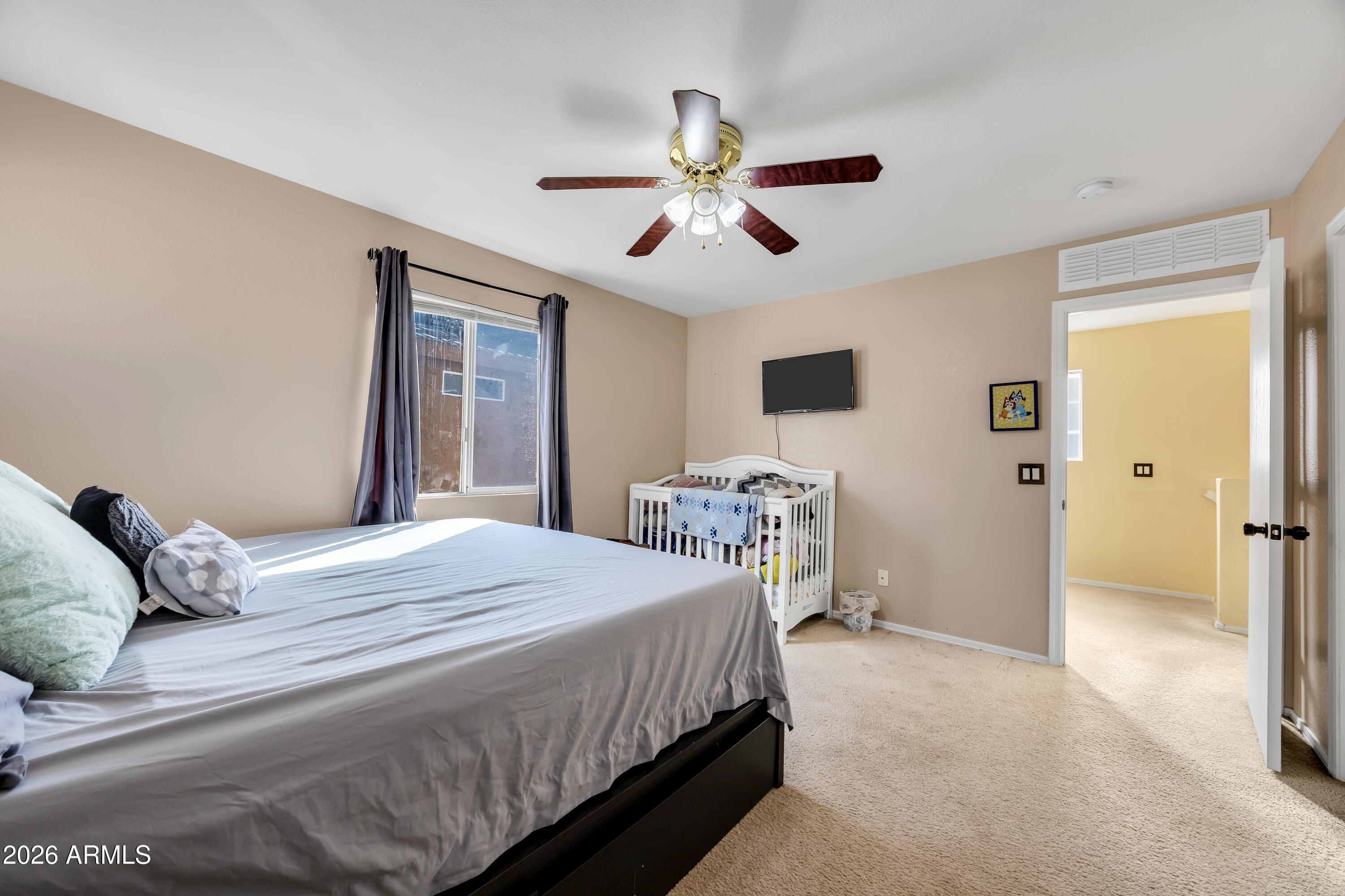 1430 East Romley Road Phoenix, AZ 85040 - Photo 22 of 24 a bedroom with a bed and a chandelier