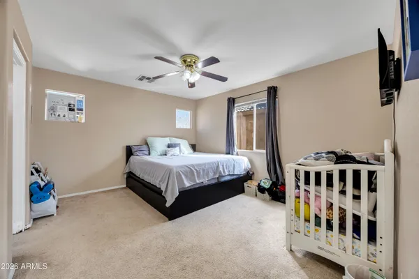 a bedroom with a bed and a chandelier