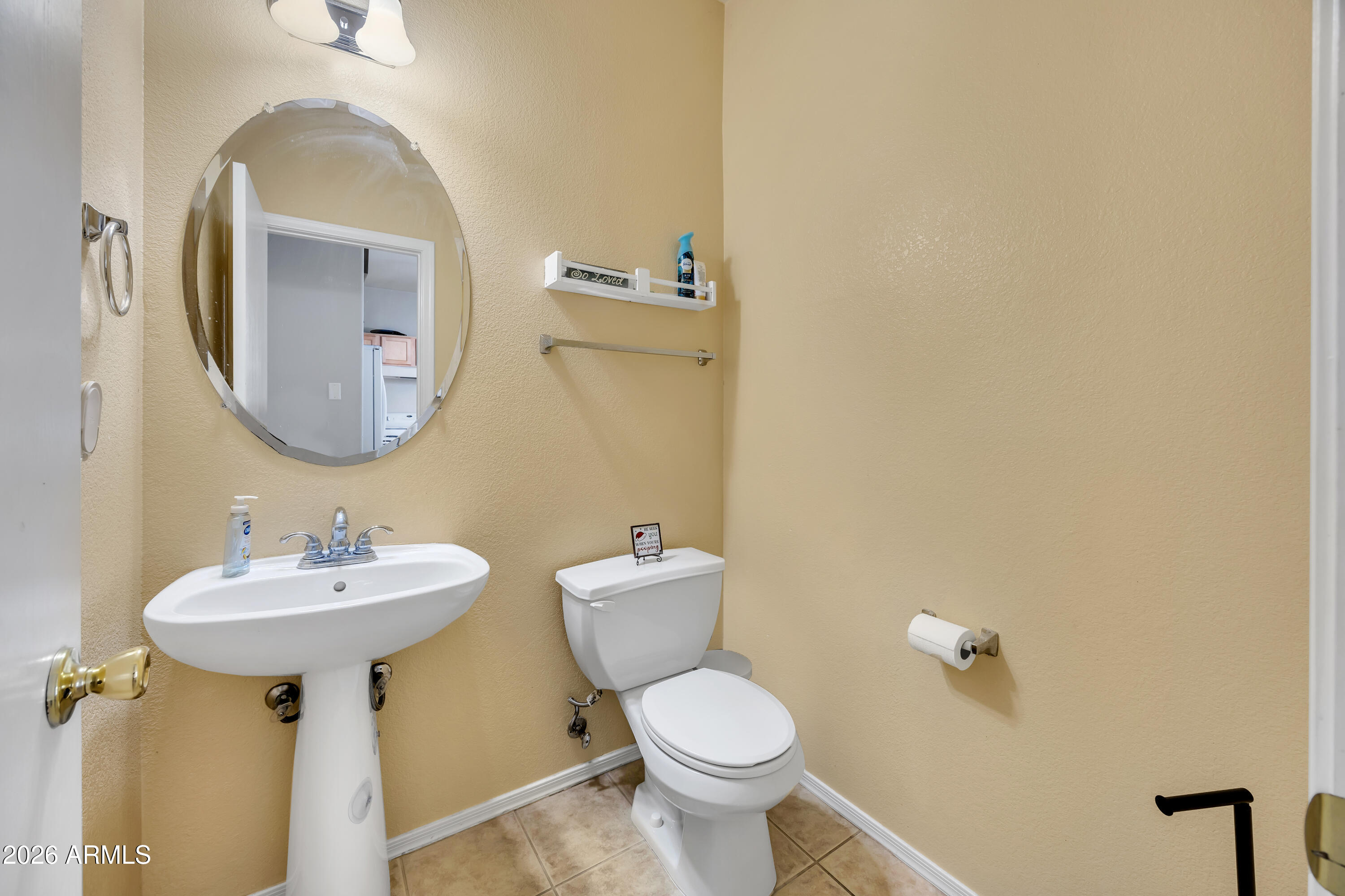 1430 East Romley Road Phoenix, AZ 85040 - Photo 24 of 24 a bathroom with a toilet sink and mirror