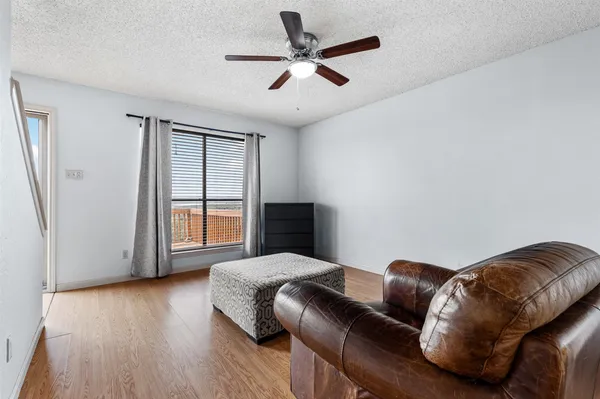 a bedroom with a bed couch and window
