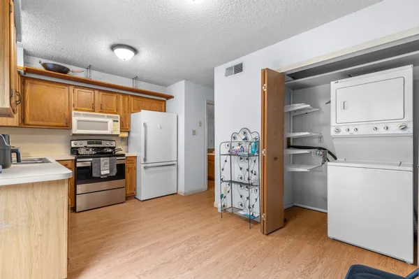 a kitchen with stainless steel appliances a refrigerator sink and microwave