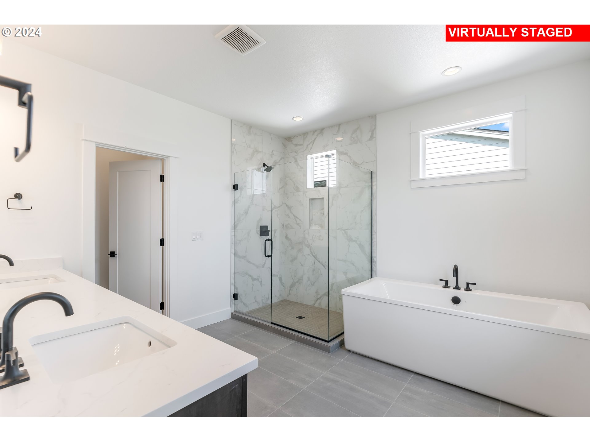 4957 North Adams Court Camas, WA 98607 - Photo 12 of 23 a bathroom with a bathtub shower sink and mirror