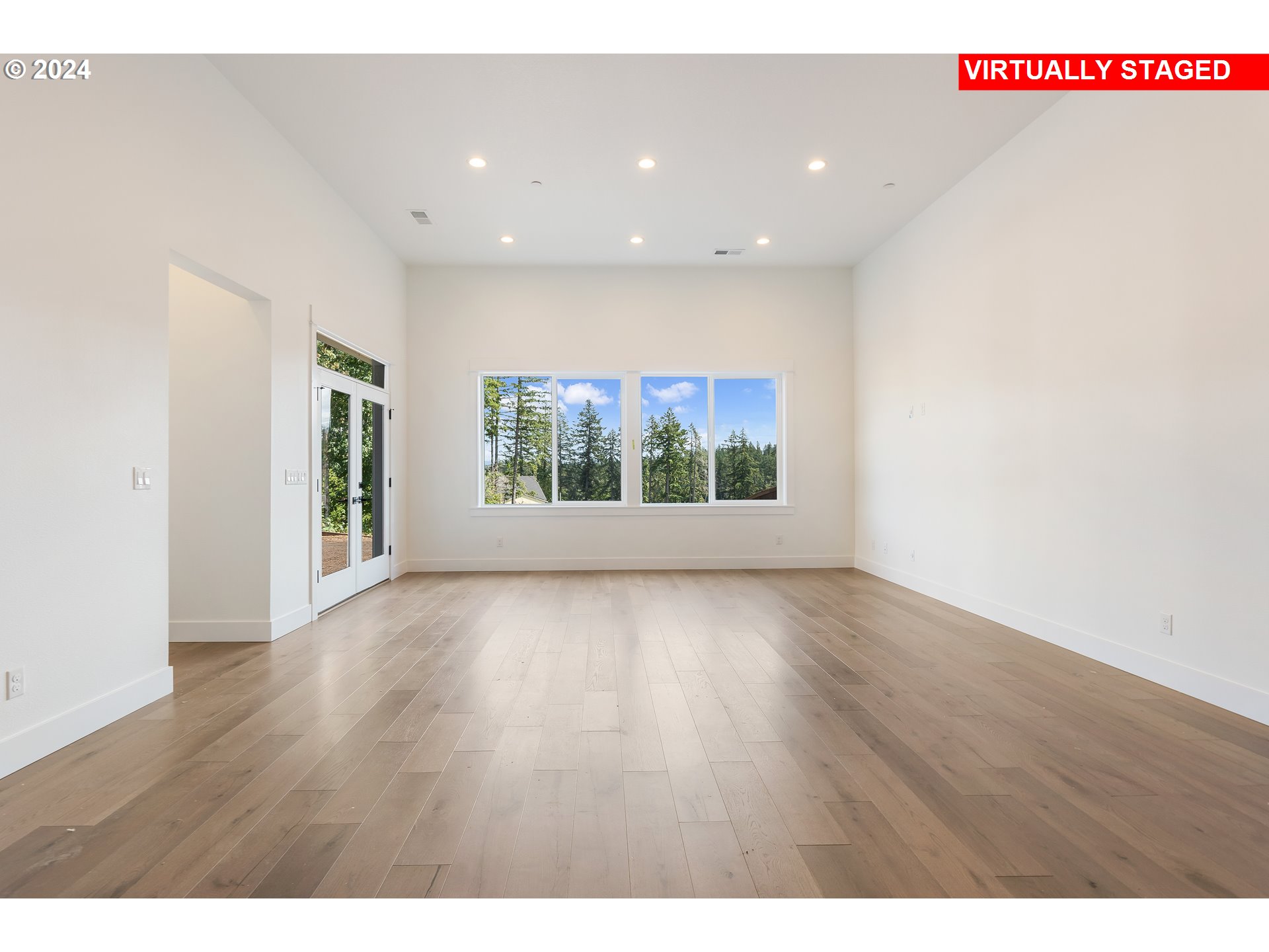 4957 North Adams Court Camas, WA 98607 - Photo 18 of 23 a view of an empty room with wooden floor and a window
