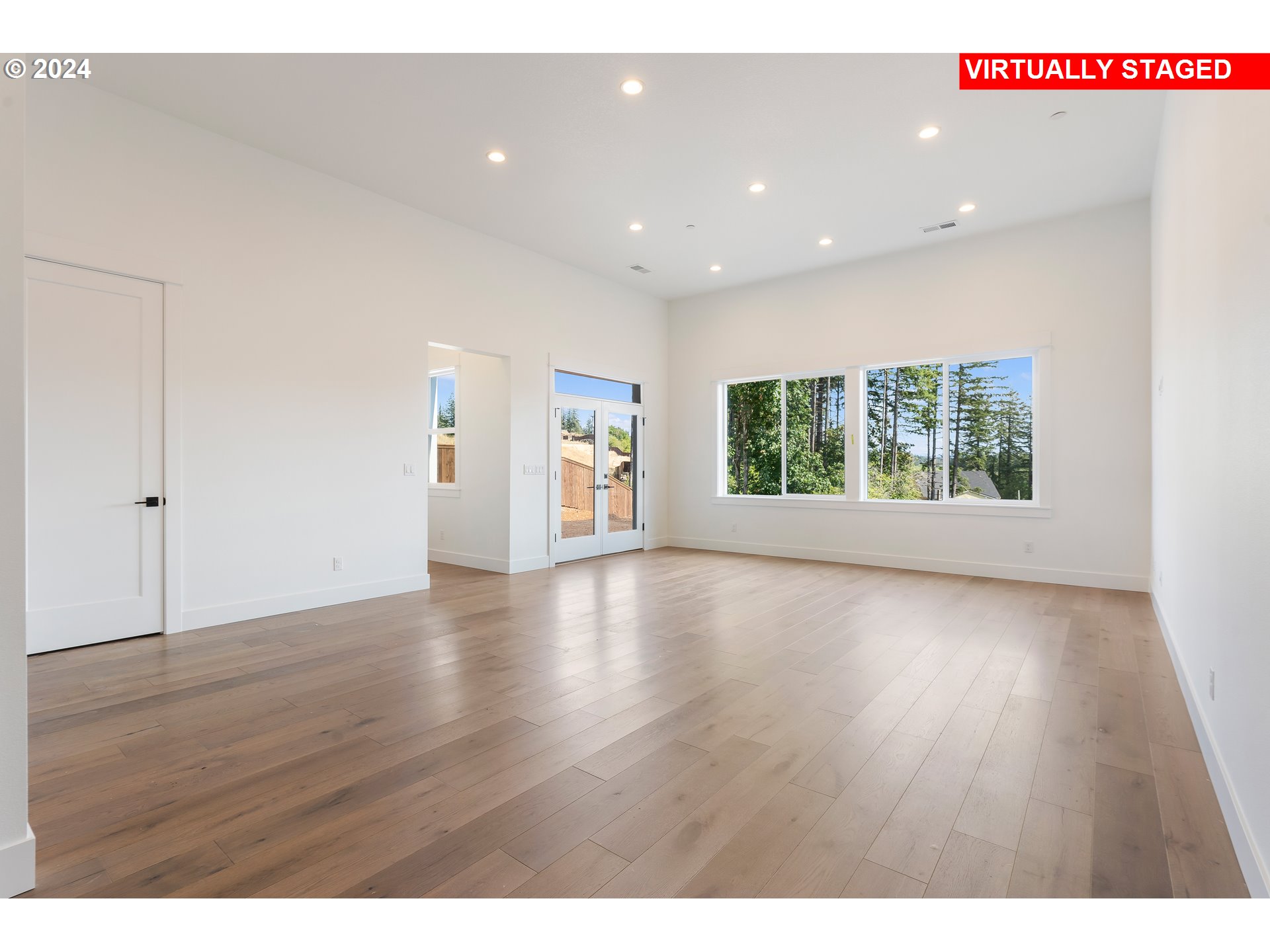 4957 North Adams Court Camas, WA 98607 - Photo 19 of 23 a view of an empty room with wooden floor and a window