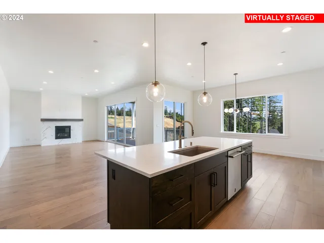 a kitchen that has a sink a stove and a wooden floor
