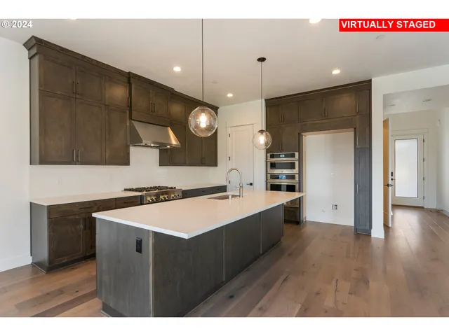 a kitchen with a sink a refrigerator and a microwave