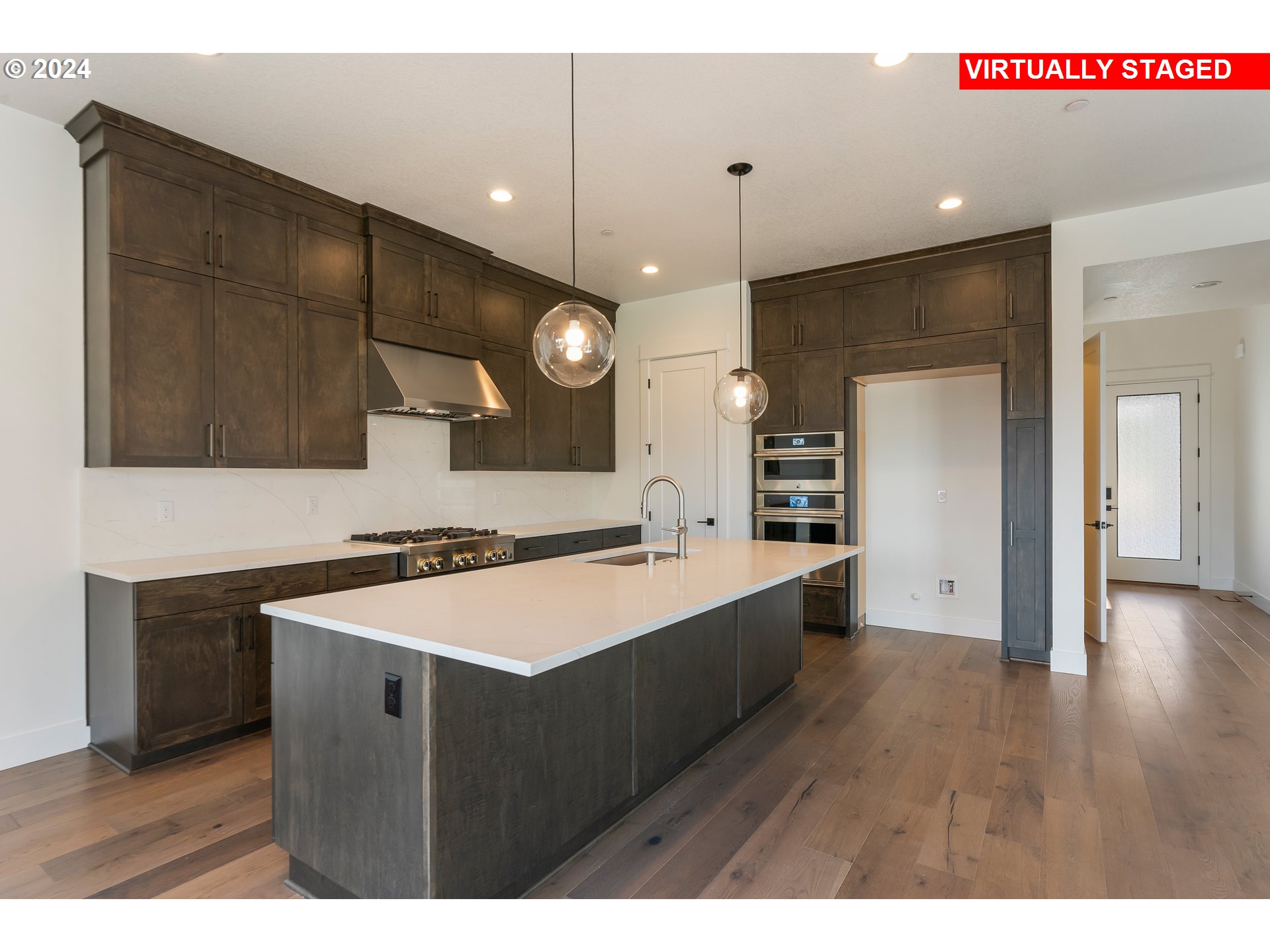 4957 North Adams Court Camas, WA 98607 - Photo 3 of 23 a kitchen with a sink a refrigerator and a microwave