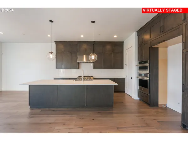 a view of a kitchen with a sink and wooden floor