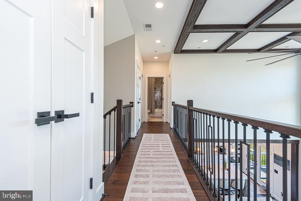 12105 Salt Point Road Bishopville, MD 21813 - Photo 54 of 117 a view of a hallway with wooden floor and staircase
