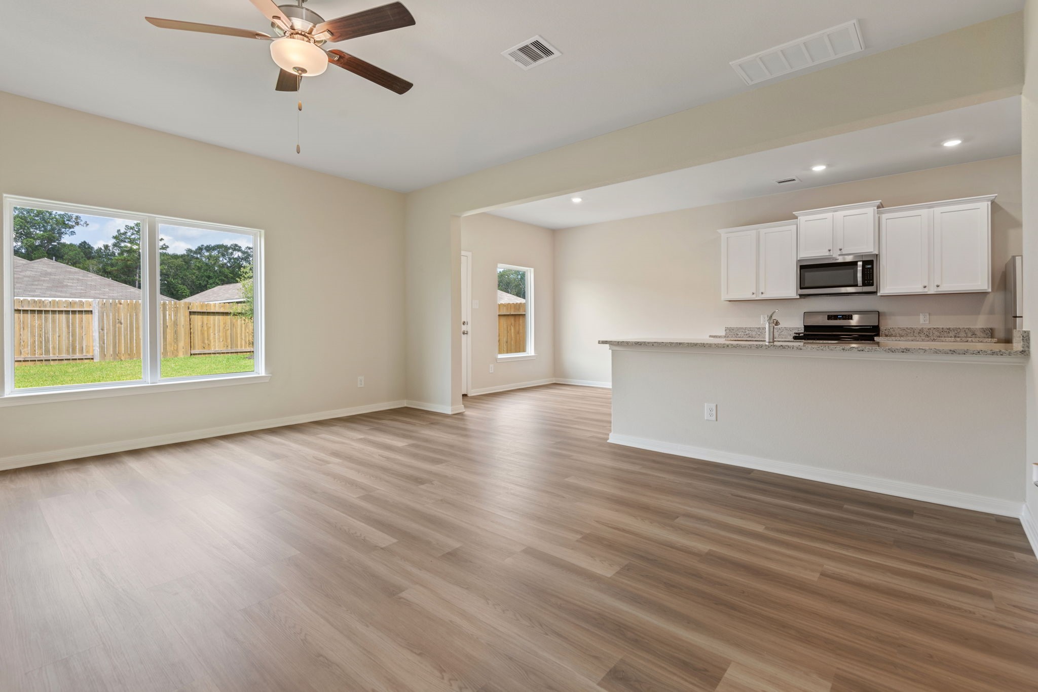 10339 Red Cardinal Drive Cleveland, TX 77328 - Photo 3 of 25 a view of a kitchen with a sink and a window