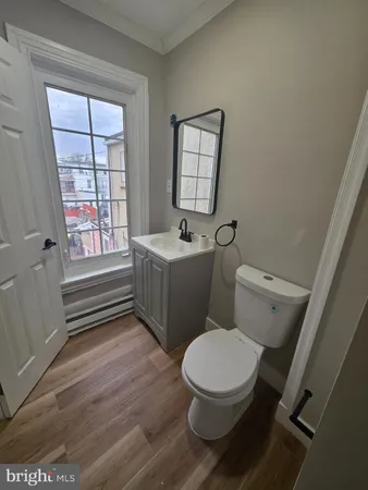 a bathroom with a sink toilet and window