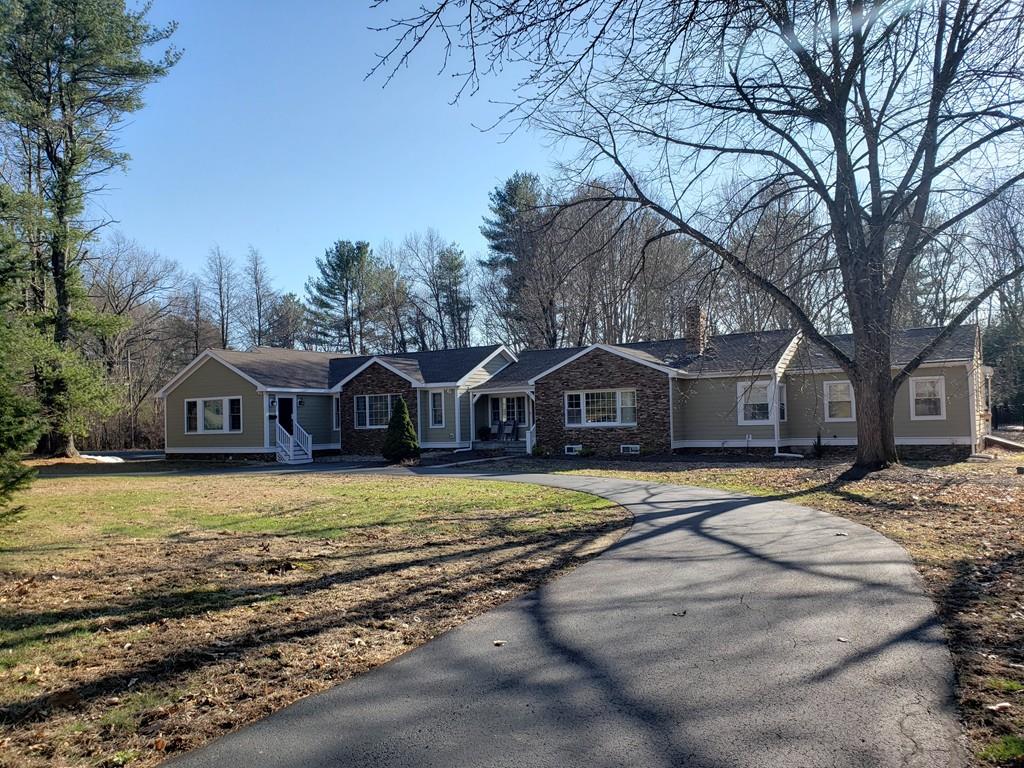 12 Hemlock Road Boxford, MA 01921 - Photo 1 of 42 a front view of a house with a yard covered with trees