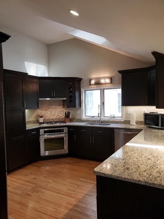 12 Hemlock Road Boxford, MA 01921 - Photo 11 of 42 a kitchen with stainless steel appliances granite countertop a sink stove and refrigerator