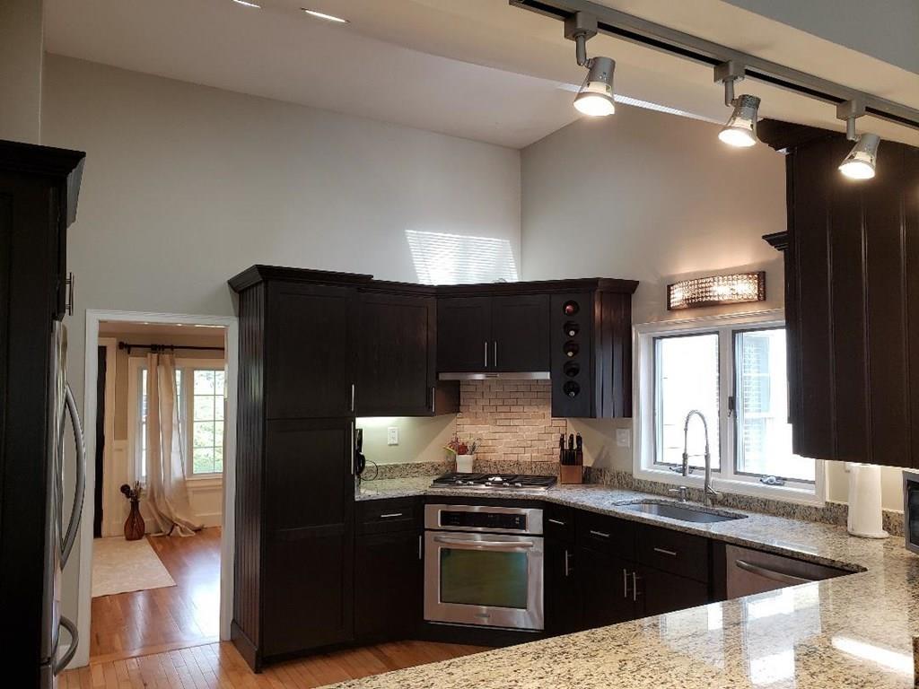 12 Hemlock Road Boxford, MA 01921 - Photo 9 of 42 a kitchen with stainless steel appliances granite countertop a sink stove and refrigerator