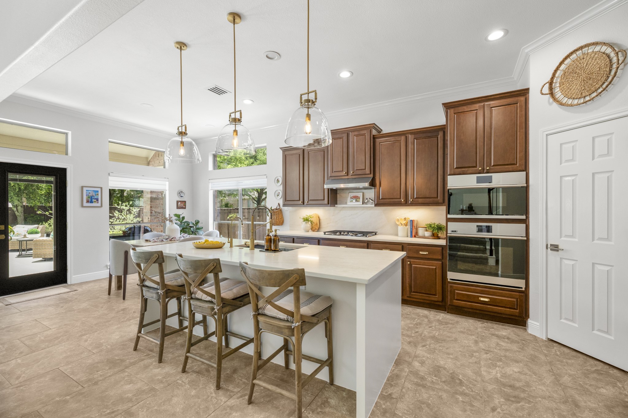 26 Winhall Place The Woodlands, TX 77354 - Photo 13 of 49 Stunning kitchen with quartz countertops and backsplash, designer glass pendants and new stainless steel appliances.