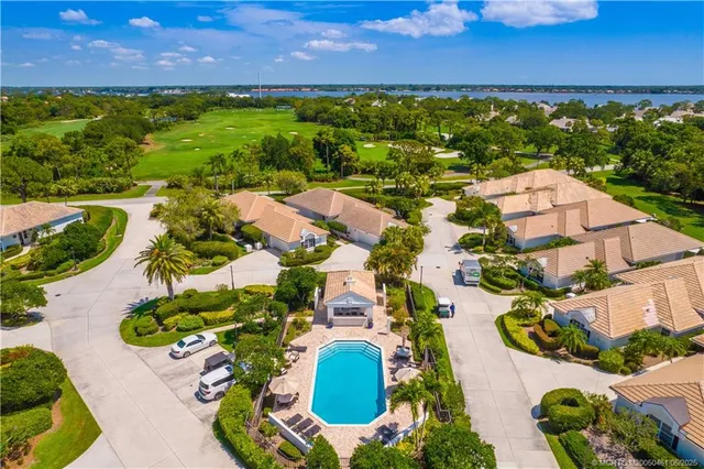 an aerial view of residential houses with outdoor space and street view
