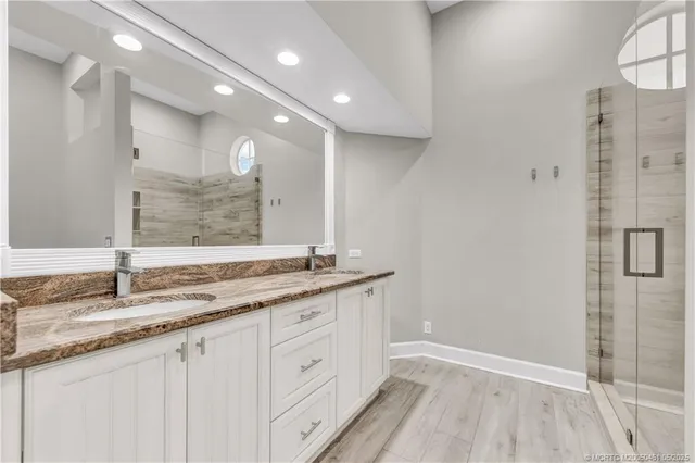 a bathroom with a granite countertop sink mirror and double