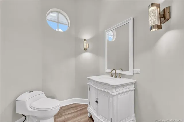 a bathroom with a sink toilet and a mirror