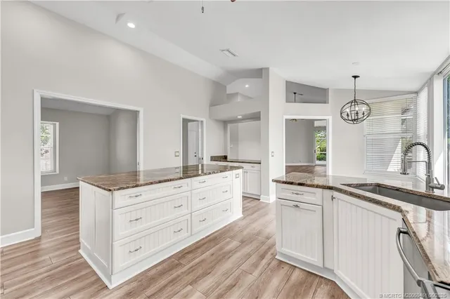 a kitchen with granite countertop a sink and cabinets