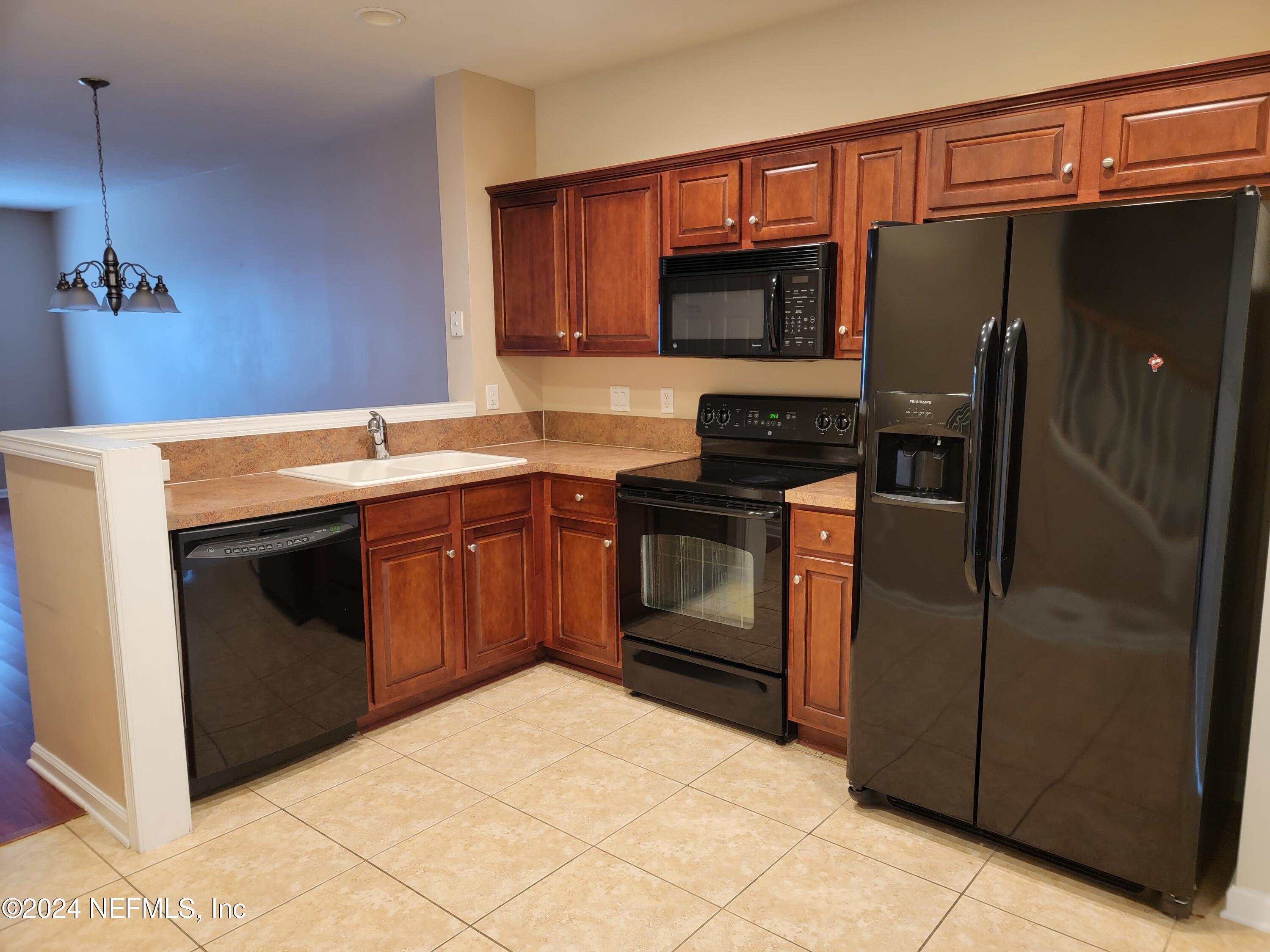 6801 Arching Branch Circle Jacksonville, FL 32258 - Photo 5 of 14 a kitchen with stainless steel appliances granite countertop a stove a refrigerator and a microwave
