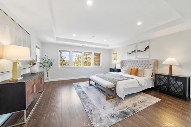 a bedroom with a bed lamp on table and a window