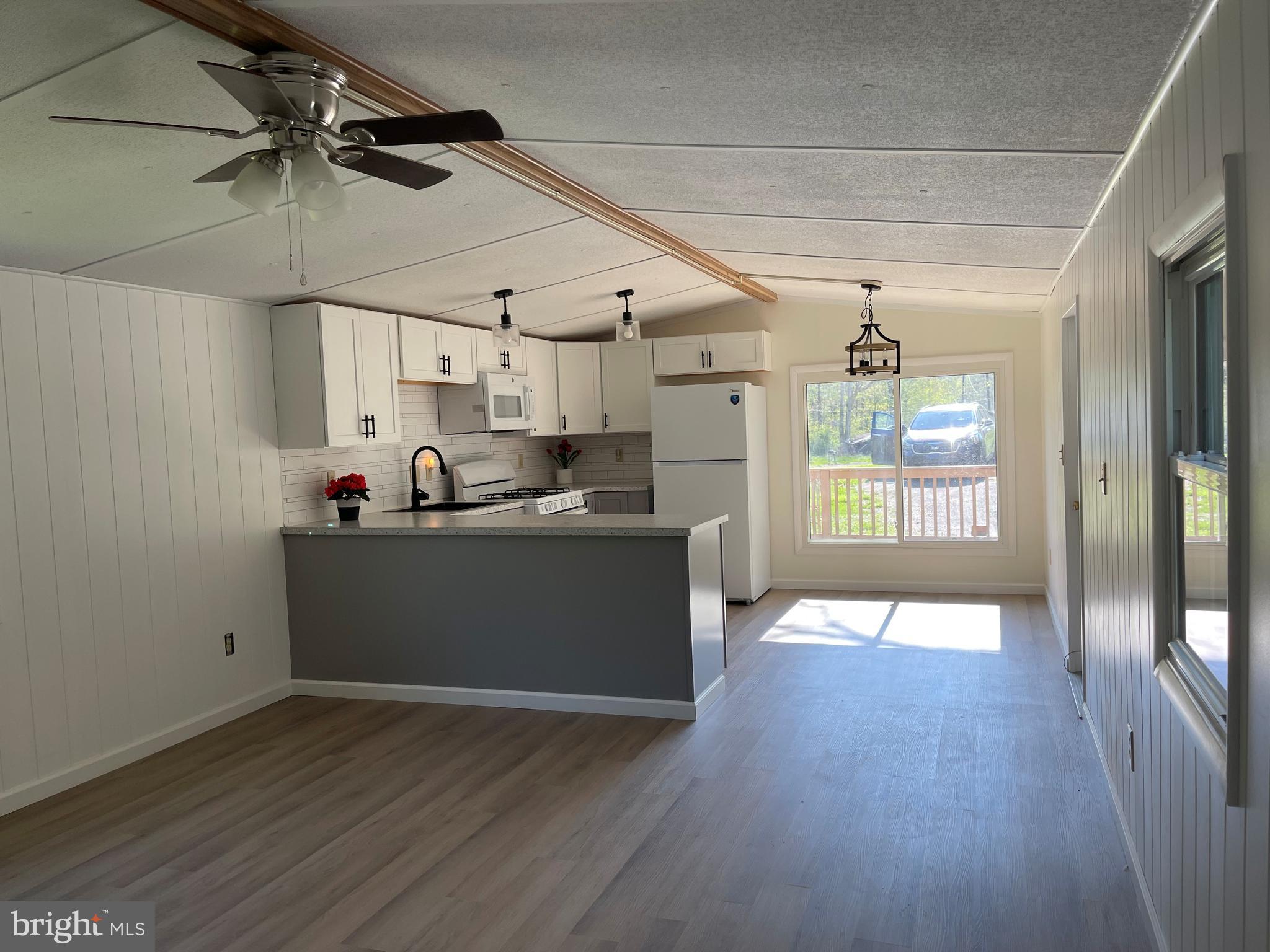 4217 Sugar Run Road Millerstown, PA 17062 - Photo 2 of 19 a kitchen with granite countertop a stove cabinets and wooden floor