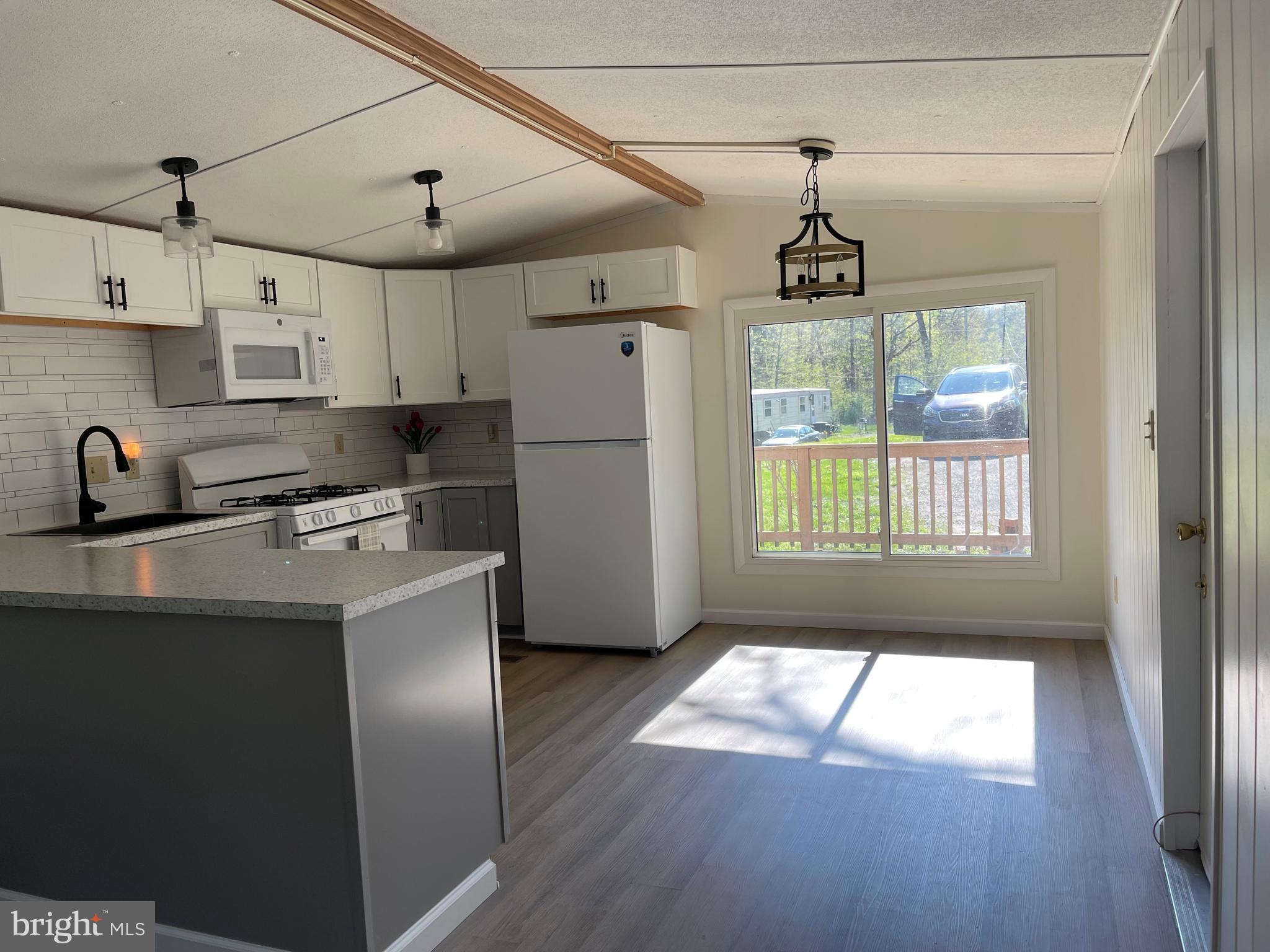4217 Sugar Run Road Millerstown, PA 17062 - Photo 3 of 19 a kitchen with stainless steel appliances a refrigerator a sink a stove a microwave and cabinets