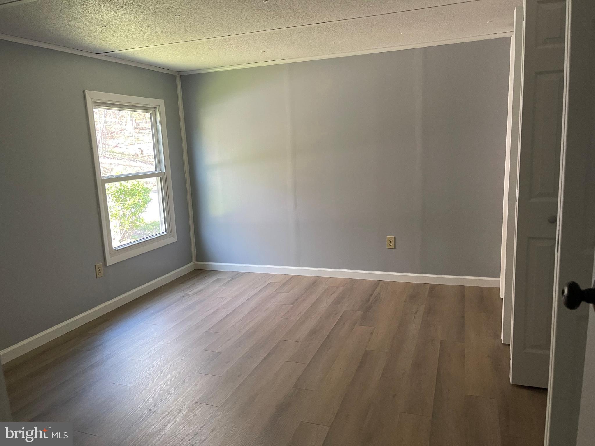 4217 Sugar Run Road Millerstown, PA 17062 - Photo 8 of 19 an empty room with wooden floor and windows