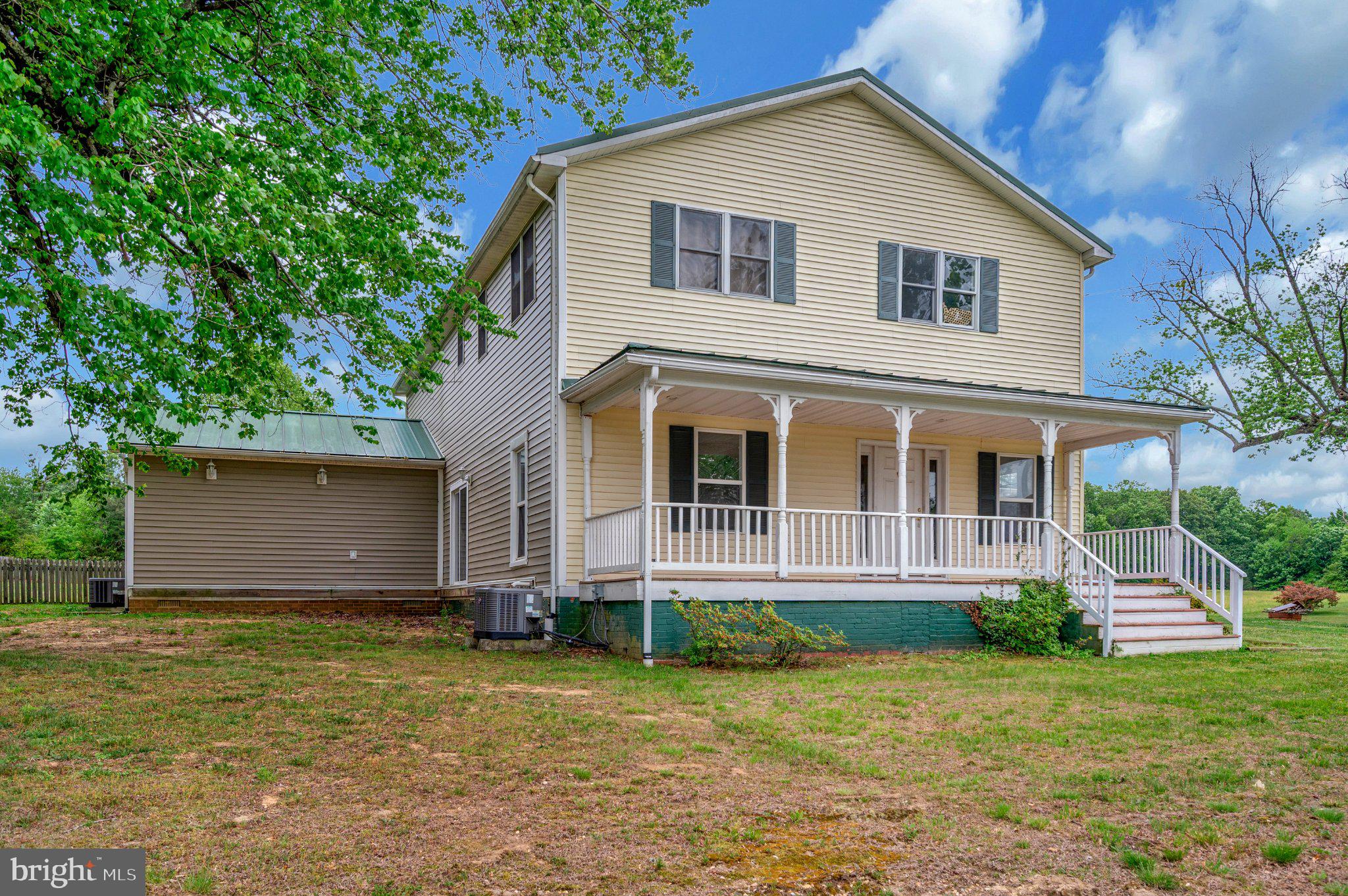 23202 Village Road Unionville, VA 22567 - Photo 50 of 58 a view of a yard in front of a house with plants and large tree