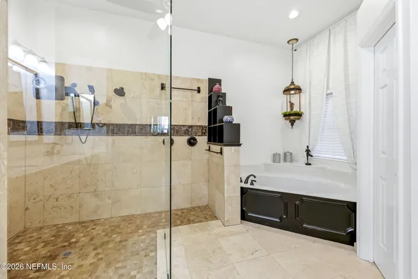 a bathroom with a shower sink and mirror