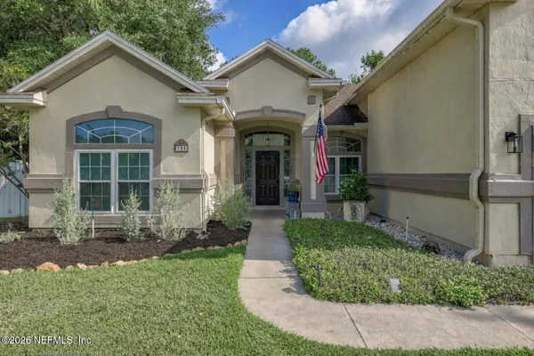 a front view of a house with garden