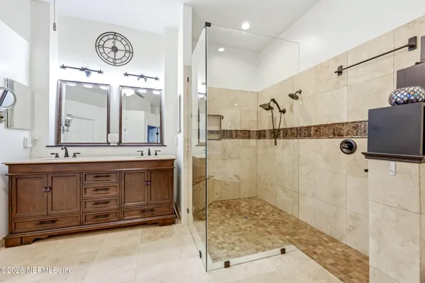 a bathroom with a granite countertop sink mirror and shower