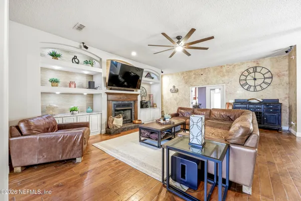 a living room with furniture fireplace and flat screen tv