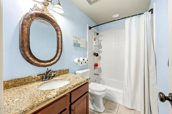 a view of storage and utility room with a window