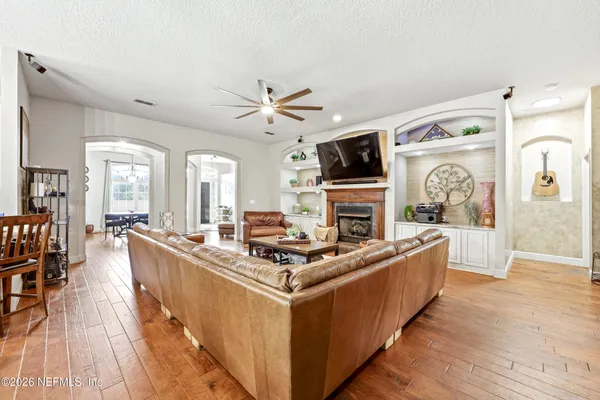 a living room with furniture a fireplace and a flat screen tv