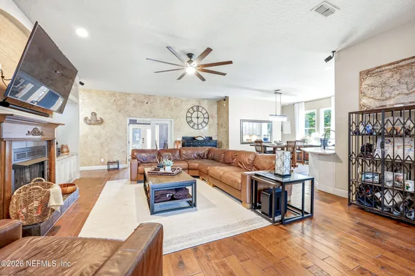 a living room with furniture a couch and a bookshelf
